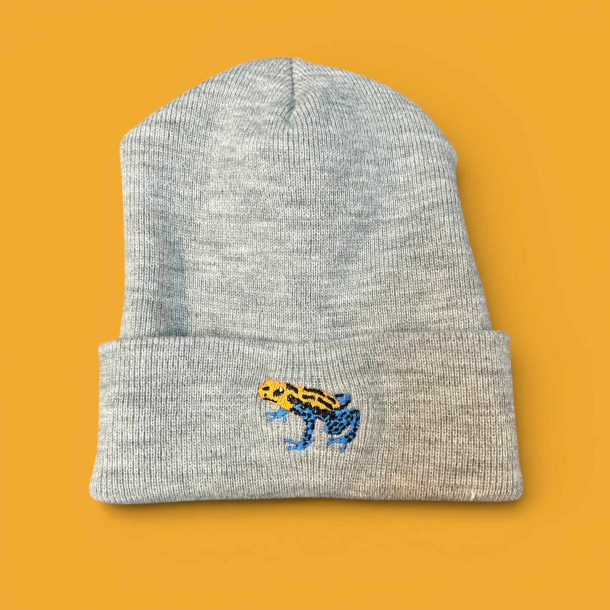 Gray beanie with an embroidered mimic poison frog design